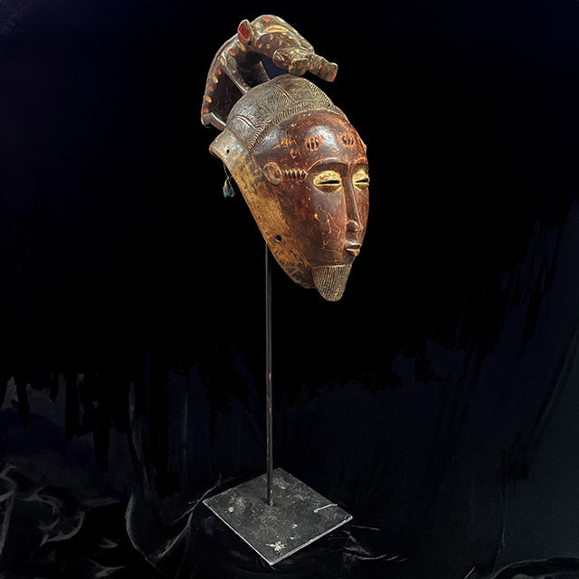African Baule Mask 130 on stand Left Side- Click to zoom. African Baule Mask 130 on stand left side
